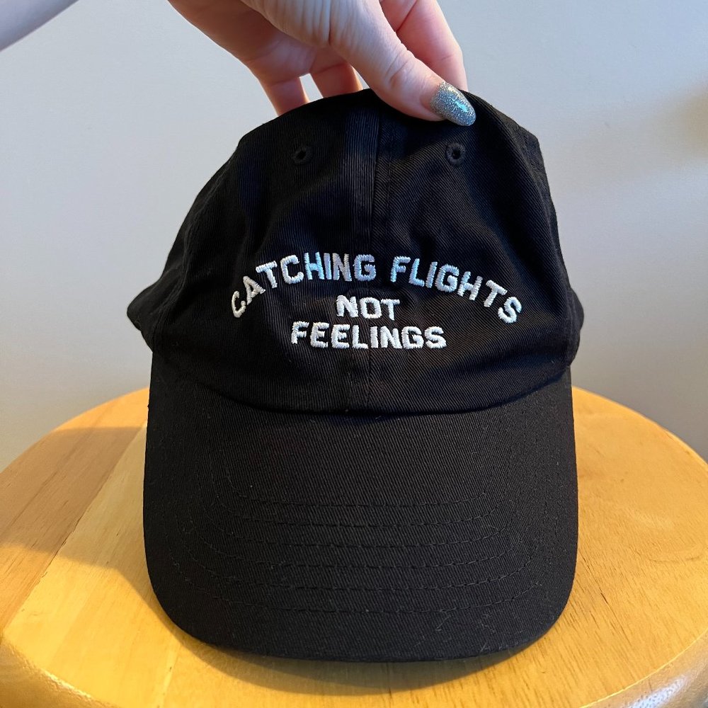 "Catching Flights Not Feelings" Black Ball Cap
